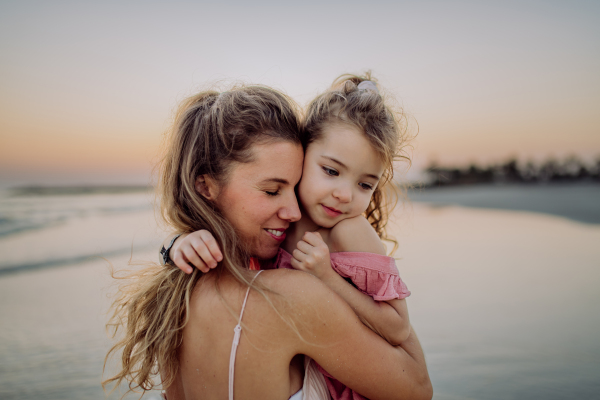 Mother enjoying together time with her daughter at the sea.