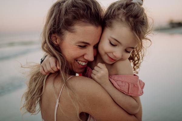 Mother enjoying together time with her daughter at the sea.