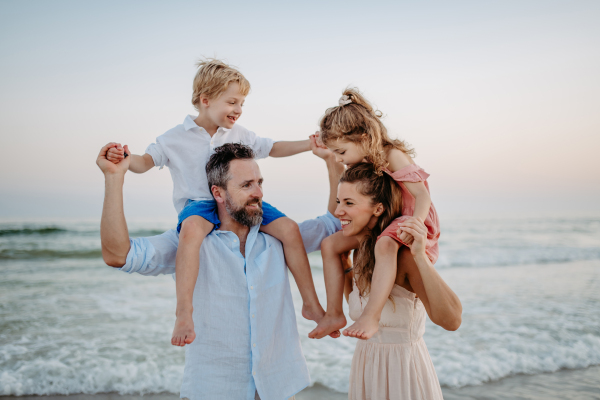 Happy family with little kids enjoying time at the sea in exotic country.