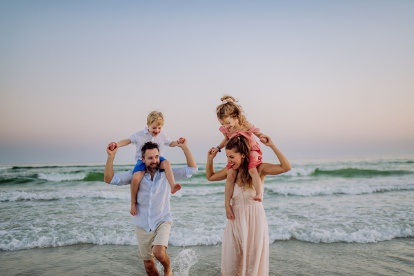 Happy family with little kids enjoying time at the sea in exotic country.