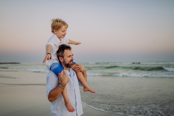 Father with his son enjoying together time at the sea.