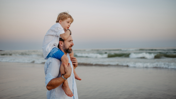 Father with his son enjoying together time at the sea.