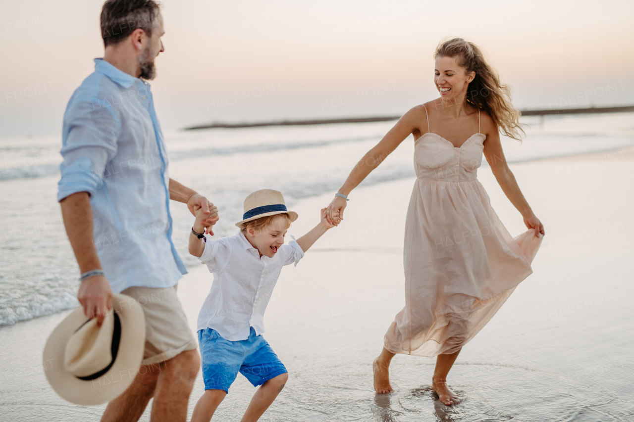 Happy family with little kids enjoying time at the sea in exotic country.