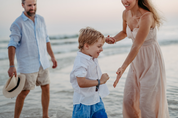 Happy family with little son enjoying time at the sea in exotic country.