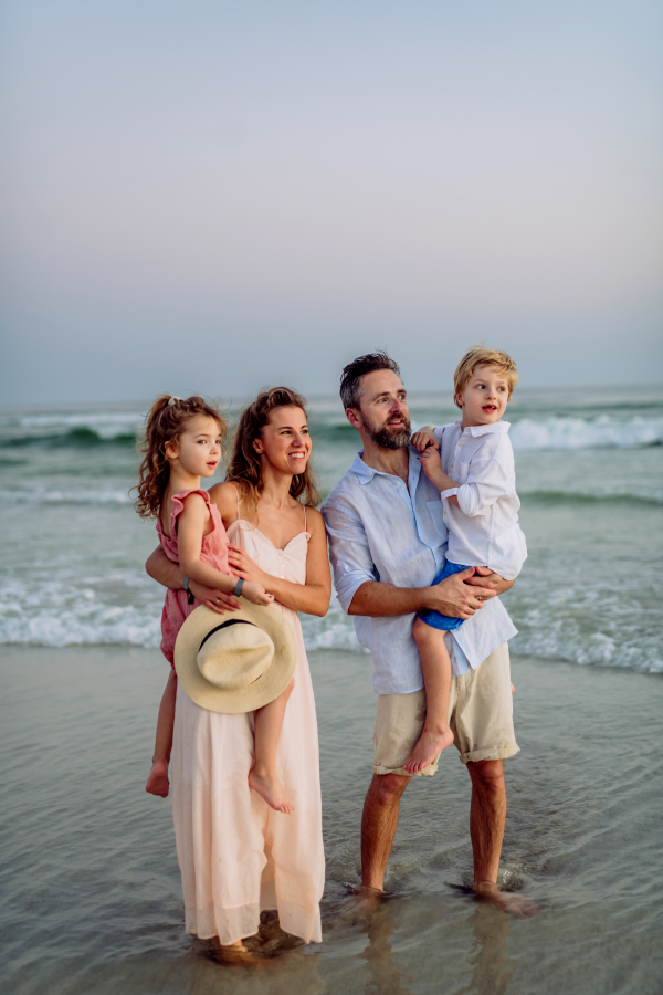 Happy family with little kids enjoying time at the sea in exotic country.