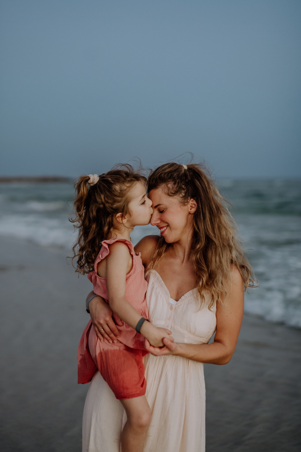 Mother enjoying together time with her daughter at the sea.