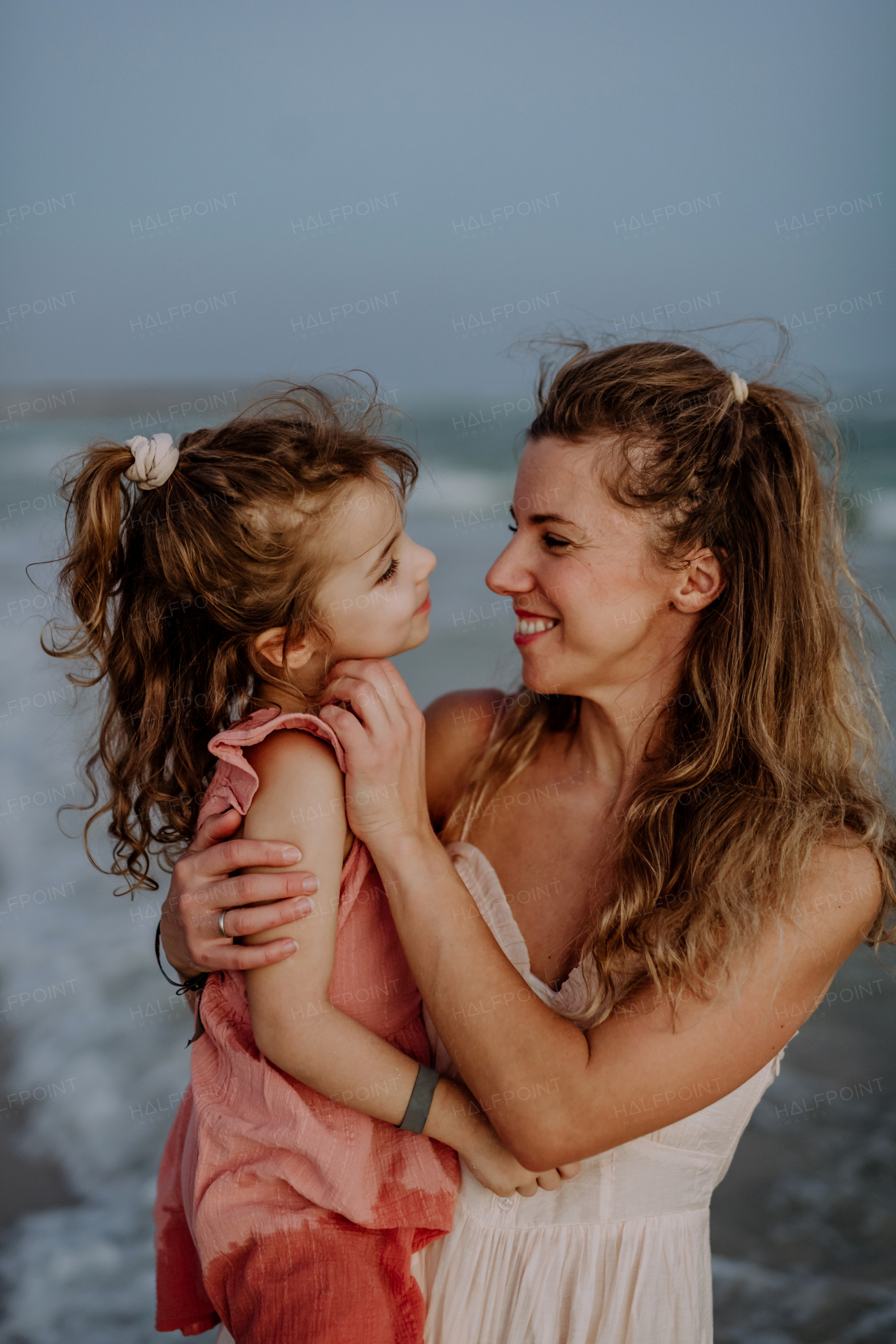 Mother enjoying together time with her daughter at the sea.