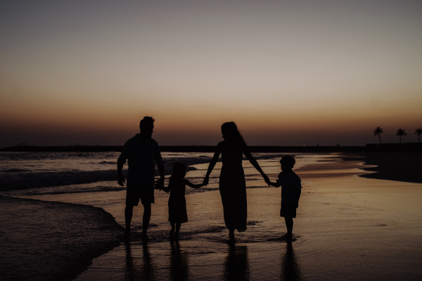 Happy family with little kids enjoying time at the sea in exotic country.