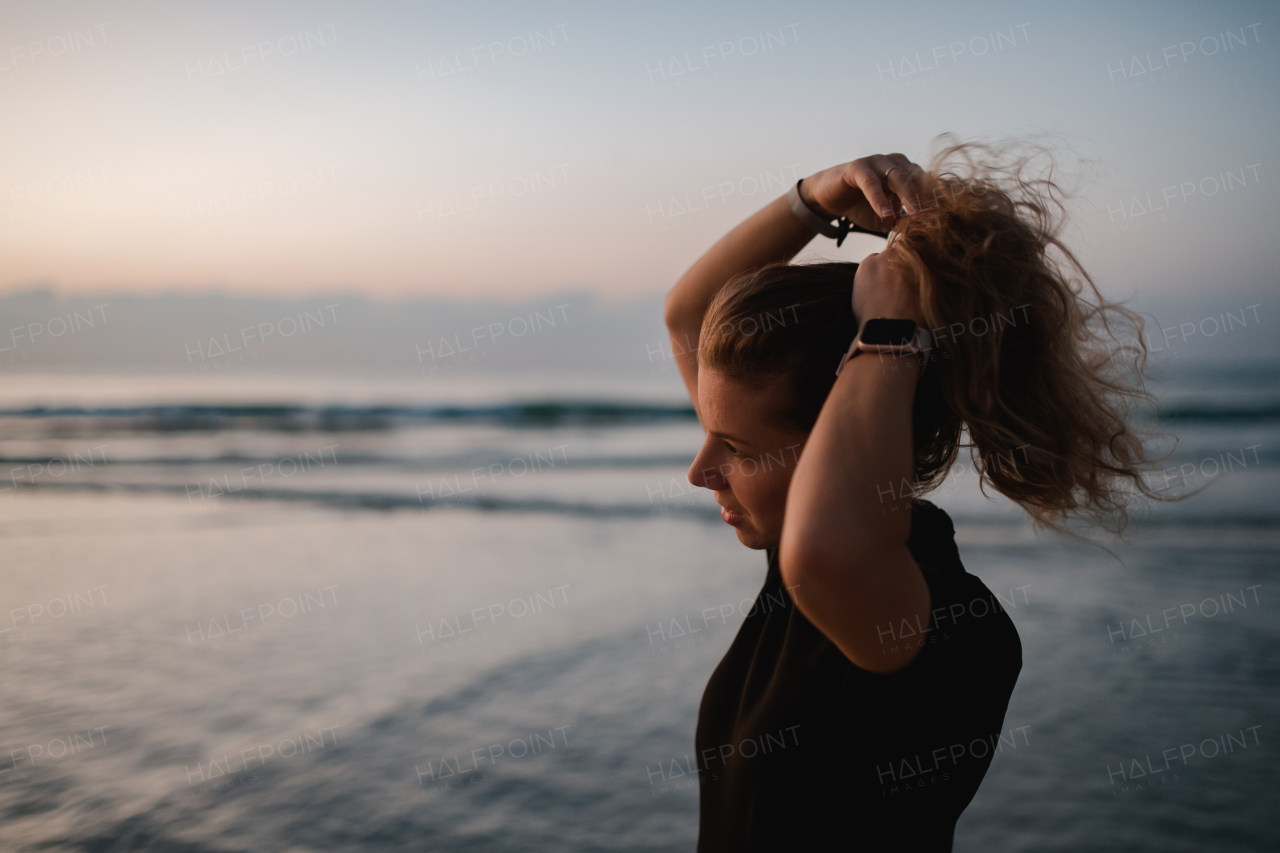 Young woman preparing for diving on the beach.