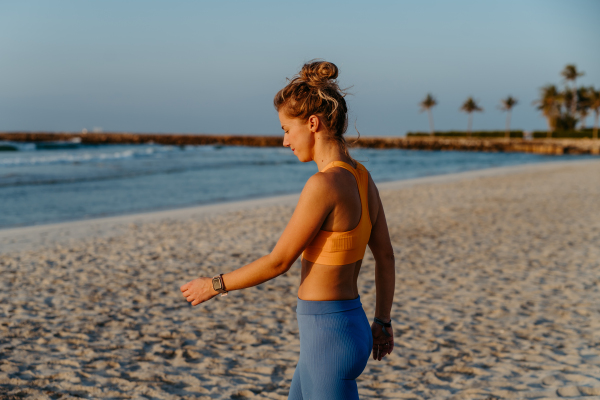 Close-up of young sportive woman at the beach.