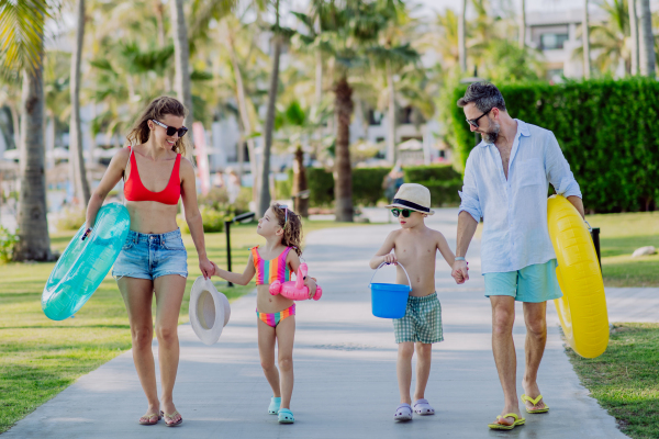 Happy family with little kids enjoying time at vaccation in exotic country.