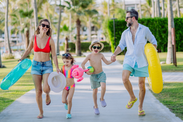 Happy family with little kids enjoying time at vaccation in exotic country.