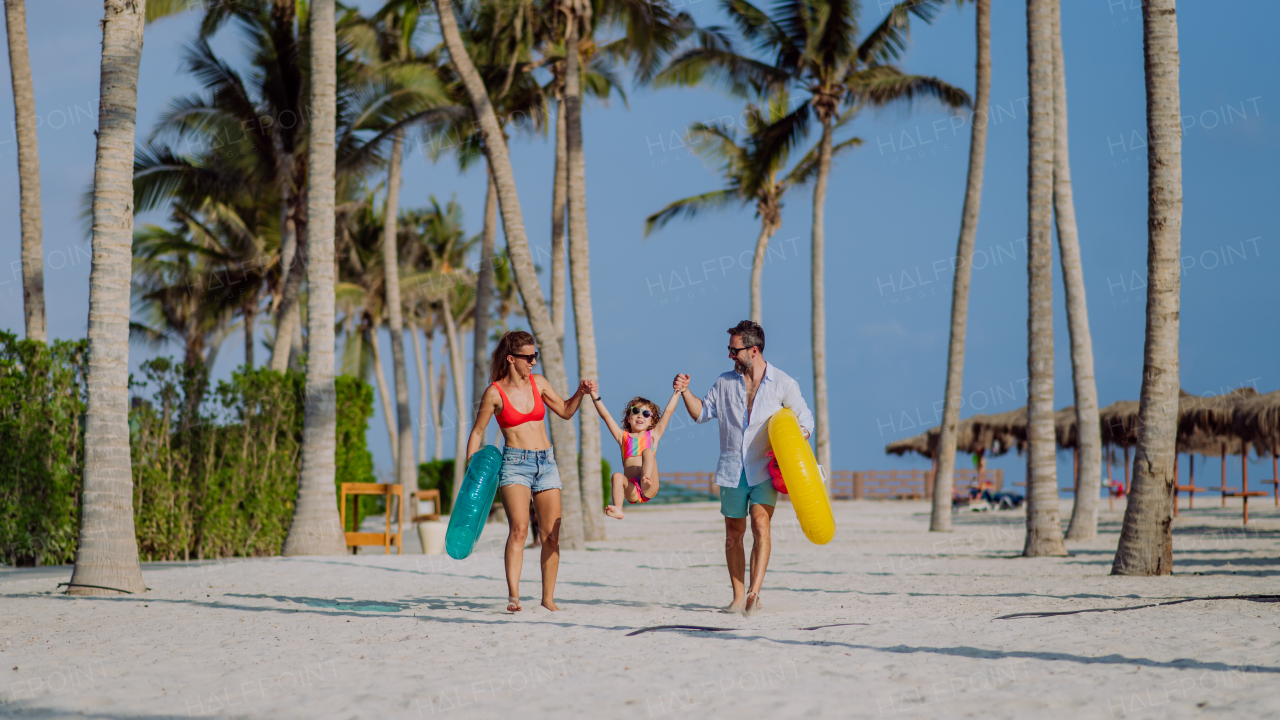 Happy family with little child enjoying time at vaccation in exotic country.