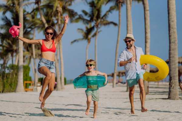 Happy family with little child enjoying time at vaccation in exotic country.