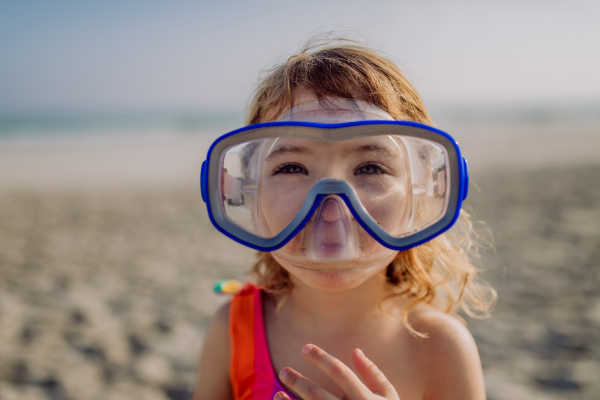 Portrait of little girl in a snorkeling mask.