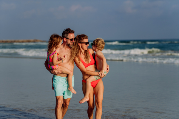 Happy family with little kids enjoying time at the sea in exotic country.