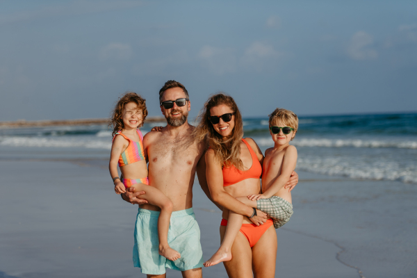 Happy family with little kids enjoying time at the sea in exotic country.