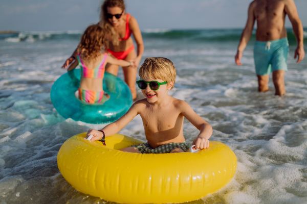 Happy family with little kids enjoying time at the sea in exotic country.