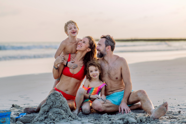 Happy family with little kids enjoying time at the sea in exotic country.