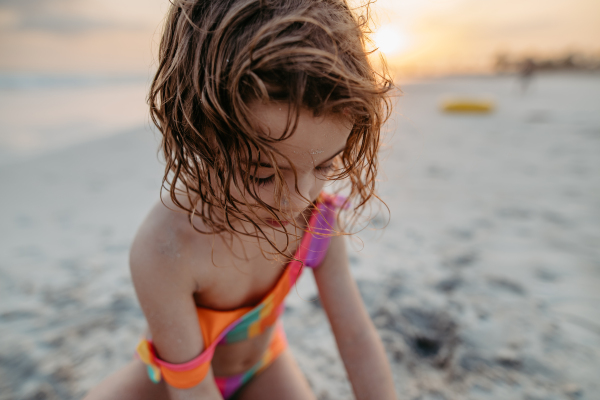 Little girl playing on a beach, close-up.