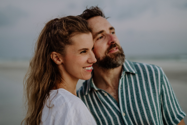 Portrait of happy couple, looking at ocean together.