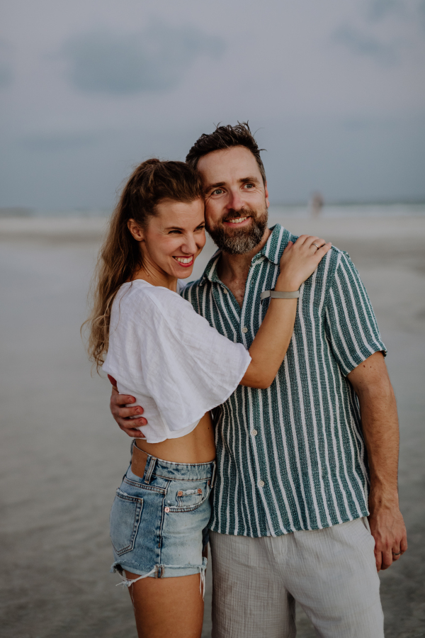 Portrait of happy couple, looking at ocean together.