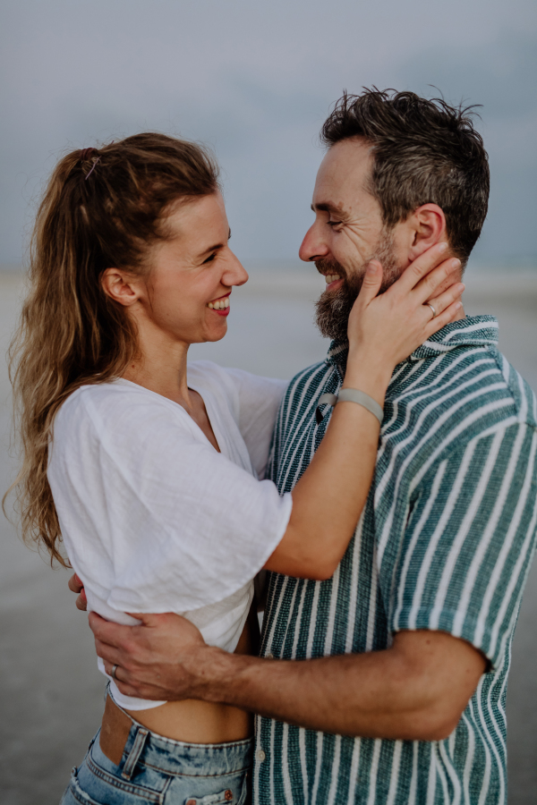 Portrait of happy couple, looking at ocean together.