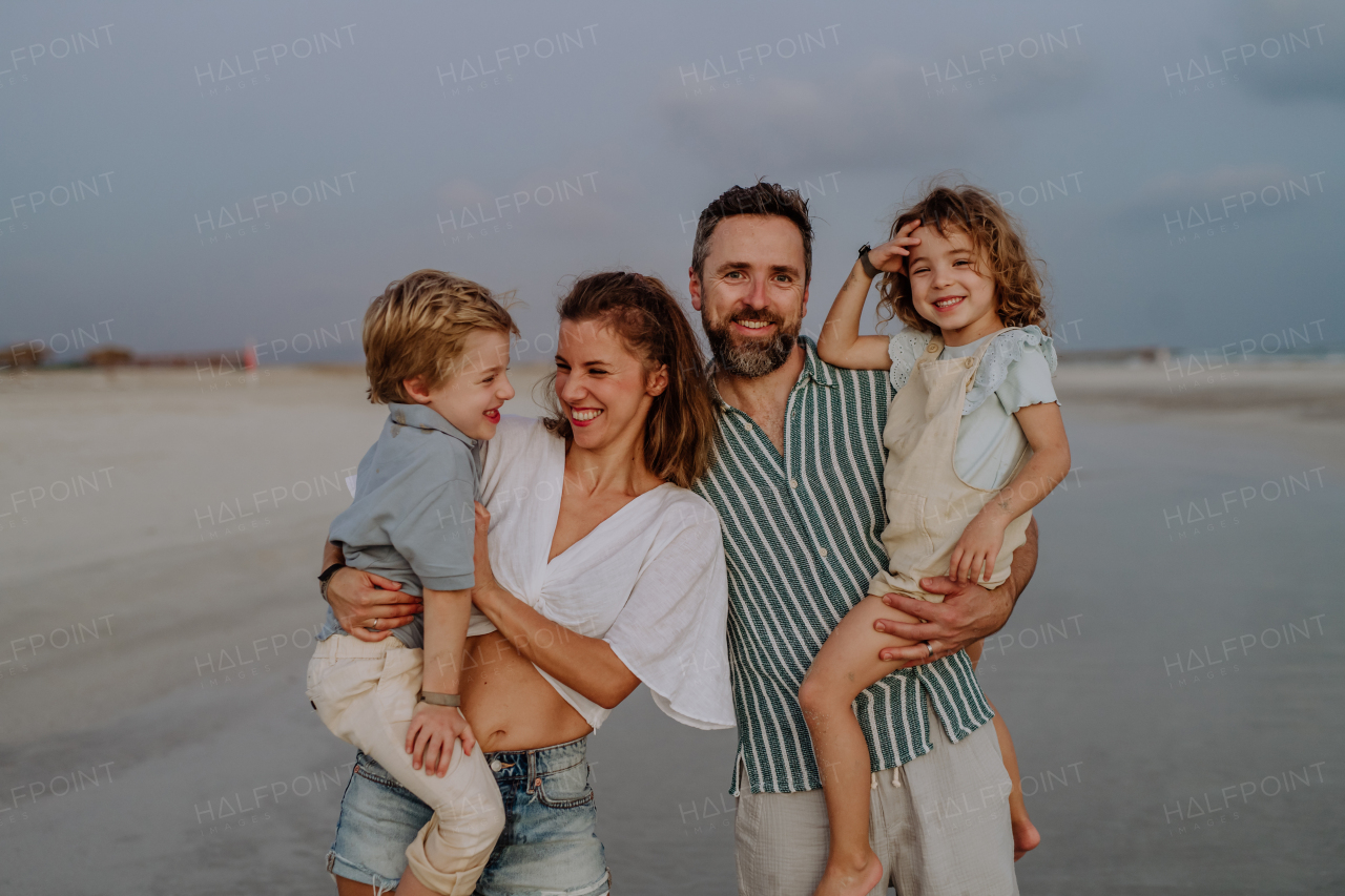 Happy family with little kids enjoying time at the sea in exotic country.