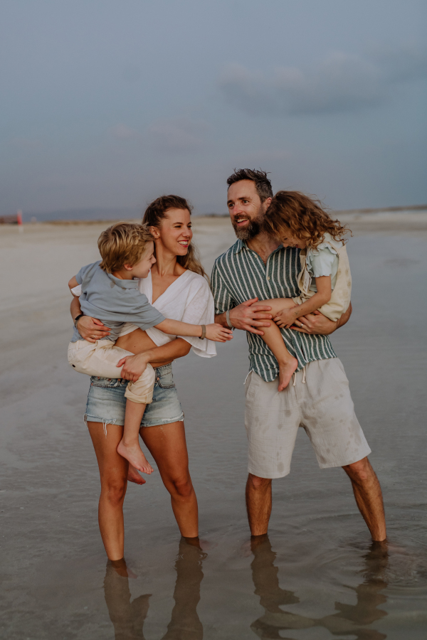 Happy family with little kids enjoying time at the sea in exotic country.