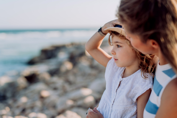 Mother enjoying together time with her daughter at the sea.