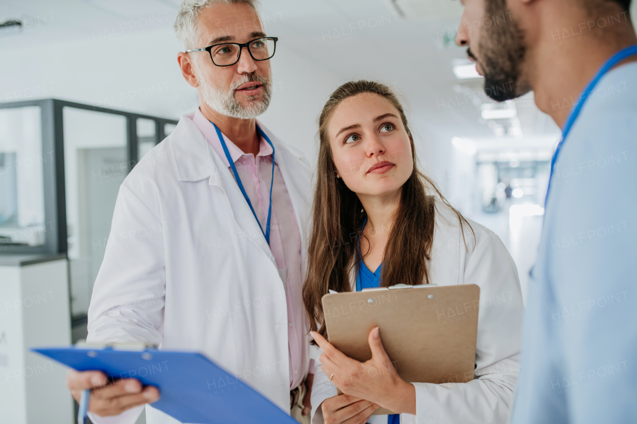 Medical staff discussing something at a hospital corridor.