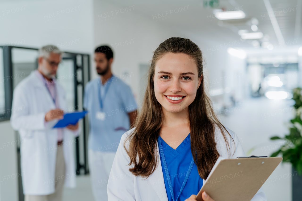 Portrait of young woman doctor at a hospital corridor.