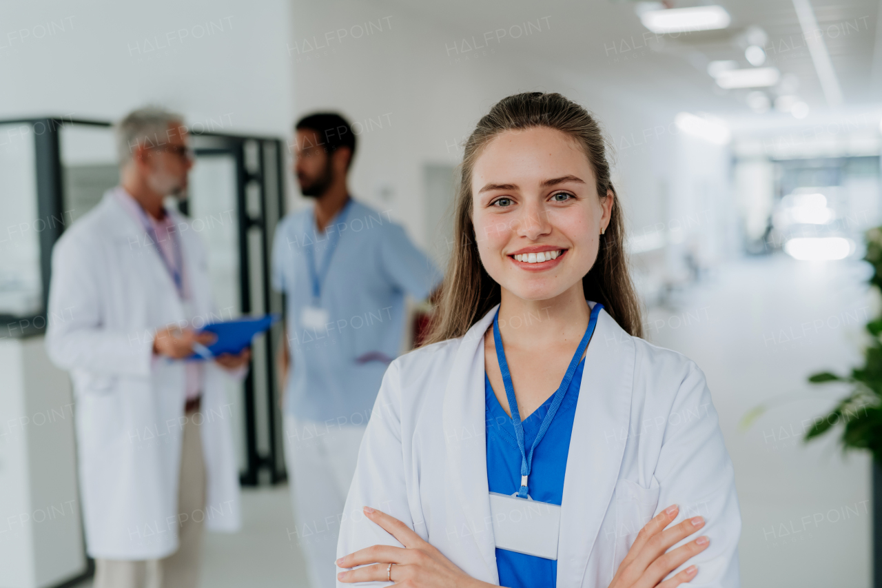 Portrait of young woman doctor at a hospital corridor.