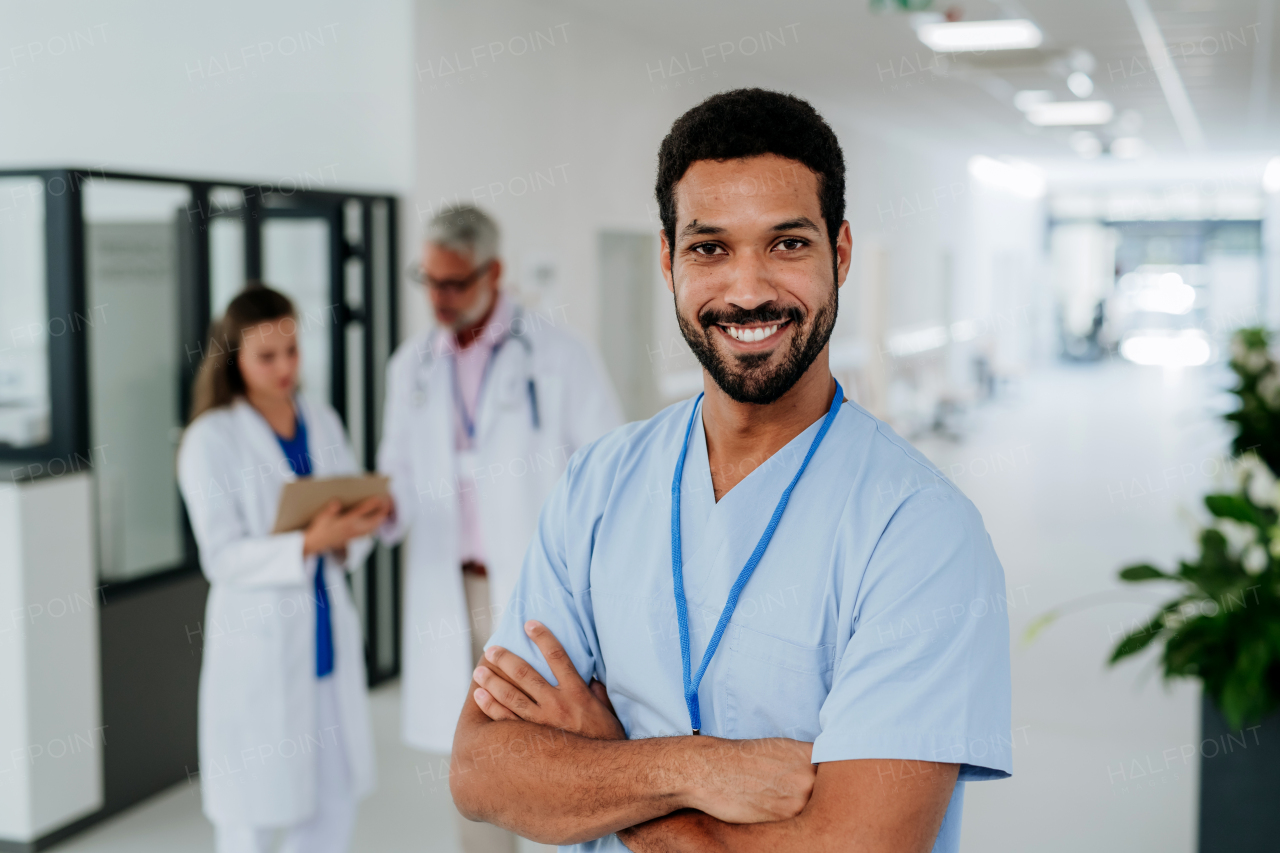 Portrait of young multiracial doctor standing at a hospital corridor.