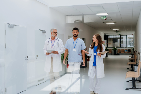 Team of doctors meeting at a hospital corridor.