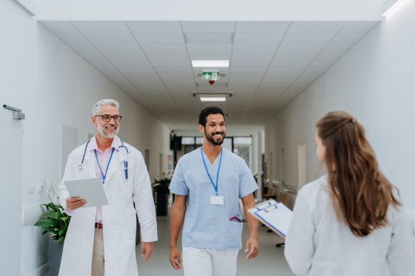 Team of doctors meeting at a hospital corridor.