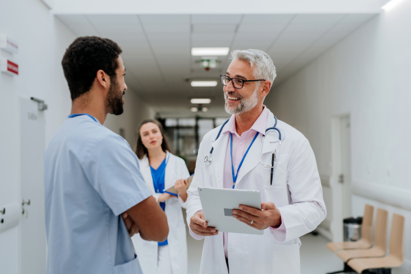 Team of doctors meeting at a hospital corridor.