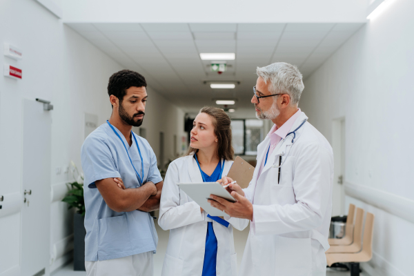 Team of doctors meeting at a hospital corridor.