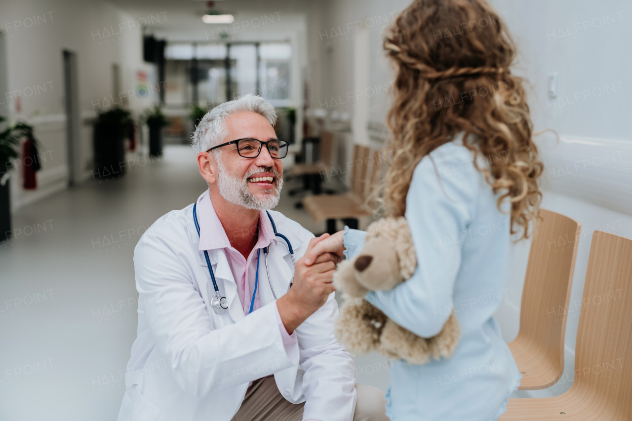 Doctor playing with the little patient at pediatrics.