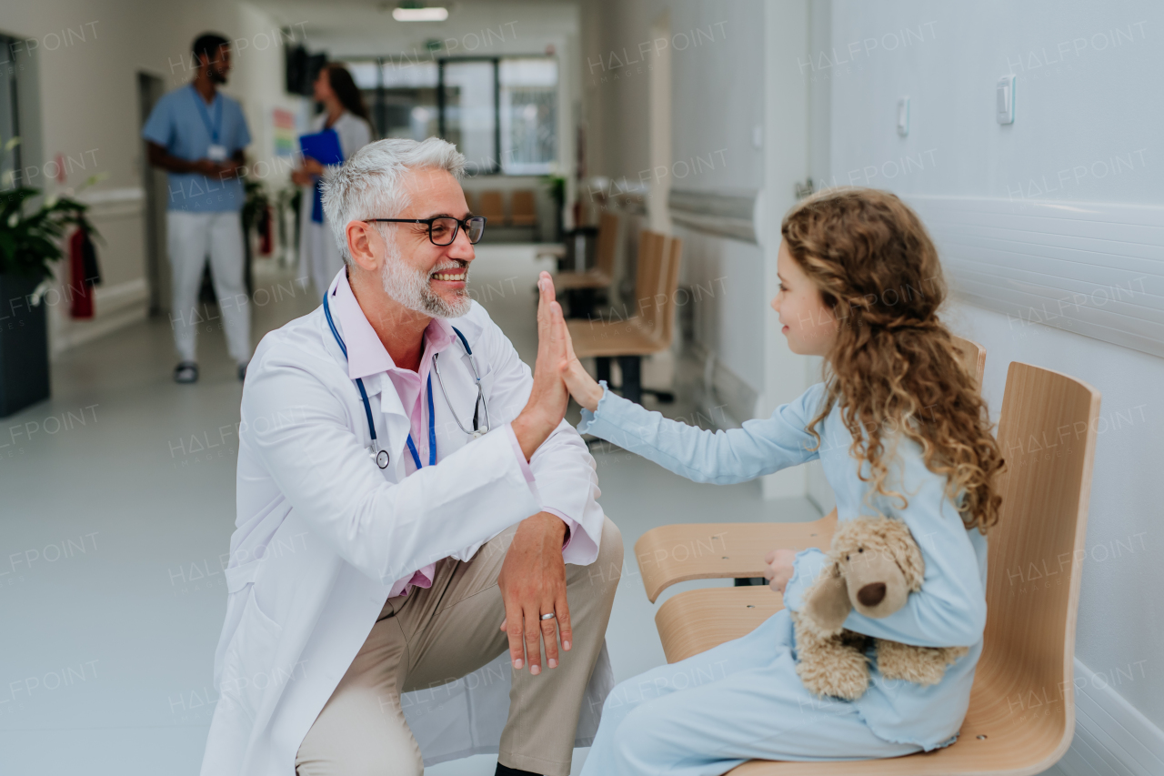 Doctor playing with the little patient at pediatrics.