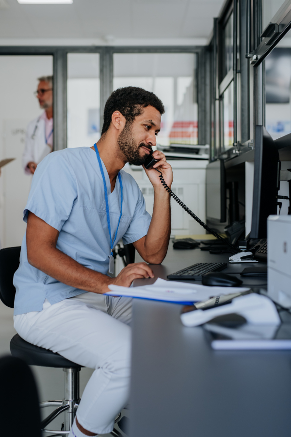 Portrait of young doctor working in the hospital reception.