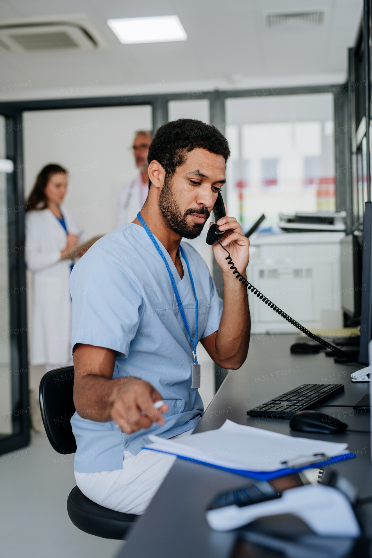 Portrait of young doctor working in the hospital reception.