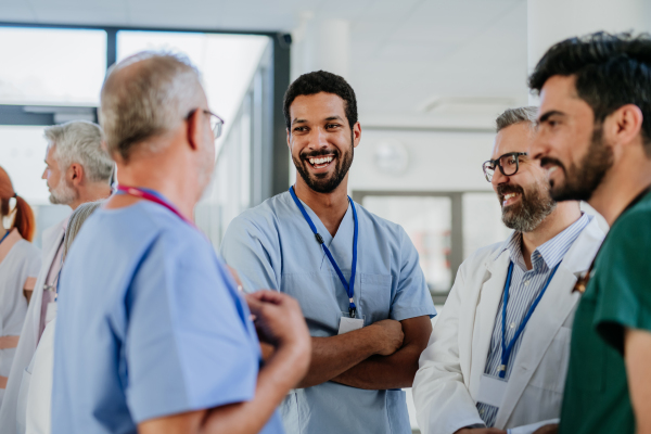 Team of doctors discussing something at a hospital corridor.