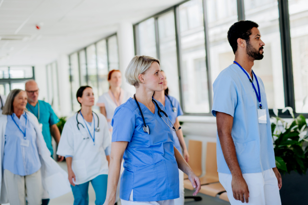 Young doctors at hospital corridor, going for daily chceck up of patients.