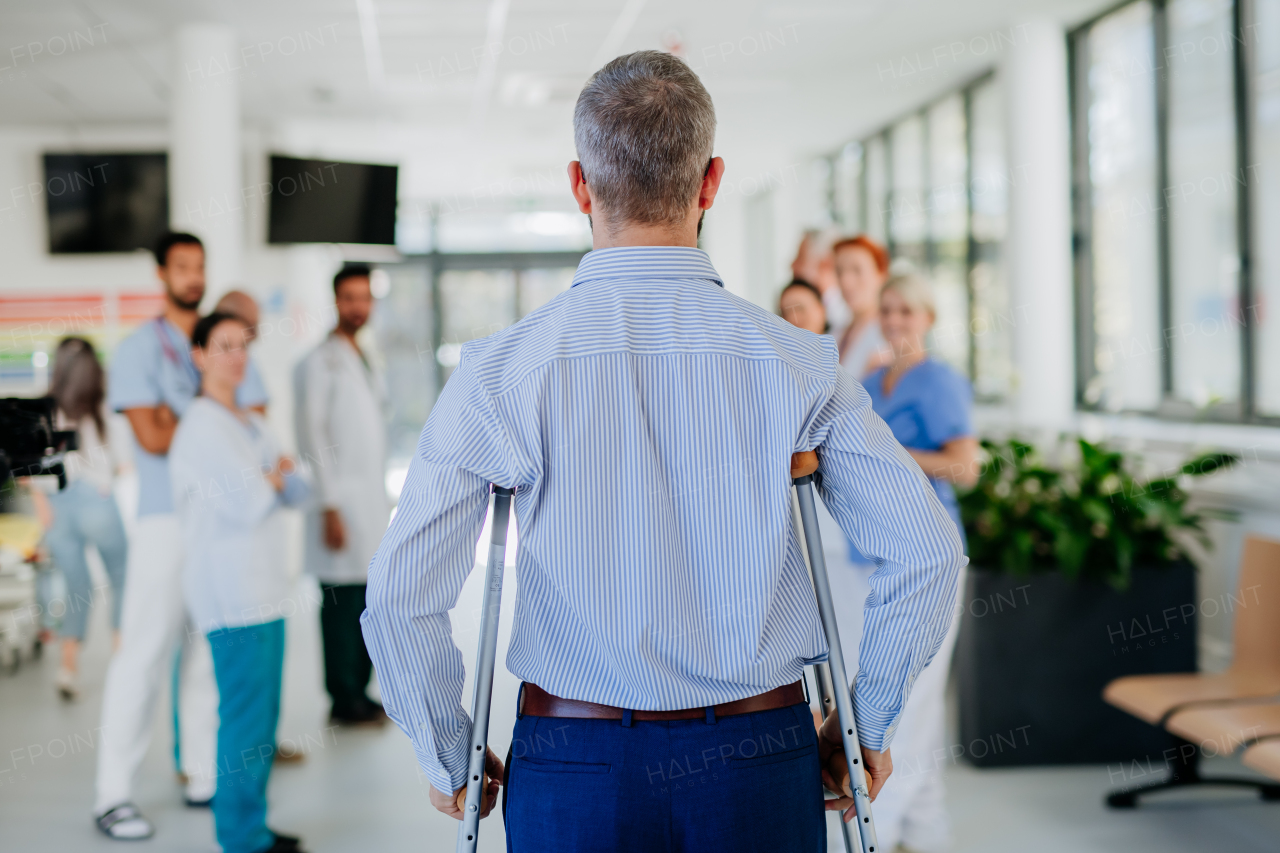 Medical staff clapping to patient who recovered from a serious accident.