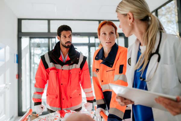 Young woman doctor taking care of patient from a rescue ambulance.