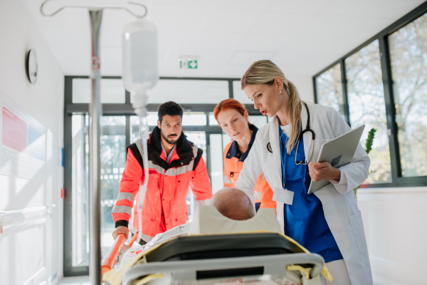 Young woman doctor taking care of patient from a rescue ambulance.