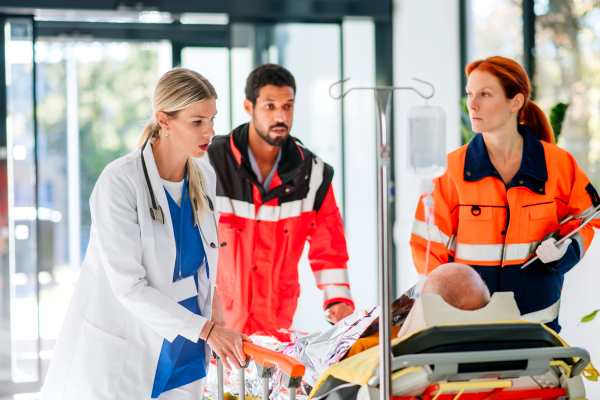 Young woman doctor taking care of patient from a rescue ambulance.