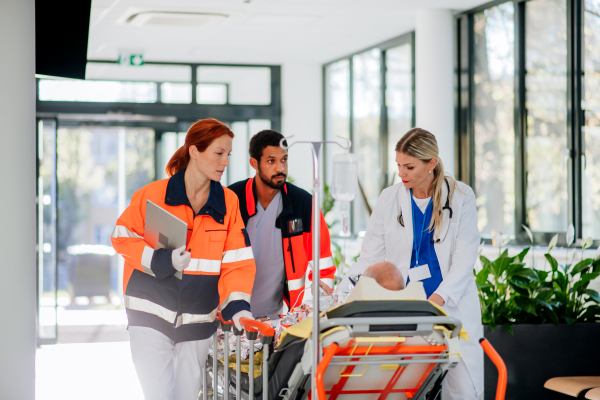 Young woman doctor taking care of patient from a rescue ambulance.