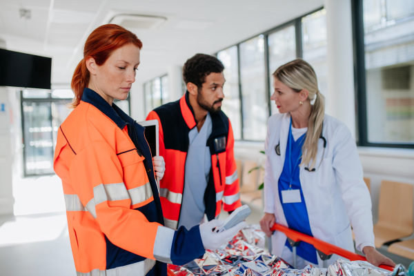 Young woman doctor taking care of patient from a rescue ambulance.